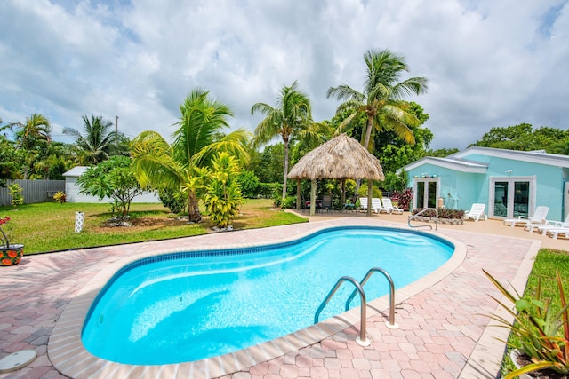 view of swimming pool with a gazebo, a patio area, a lawn, and french doors