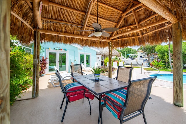 view of patio featuring a gazebo, ceiling fan, and french doors