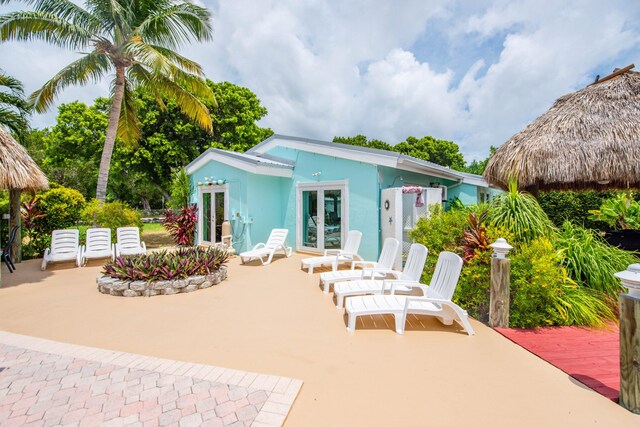 rear view of house featuring french doors and a patio