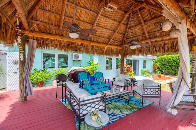 wooden deck featuring a gazebo, an outdoor hangout area, and ceiling fan