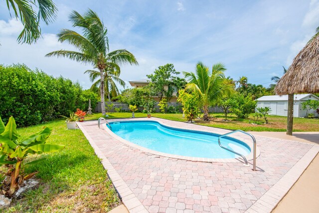 view of swimming pool featuring a patio area and a lawn