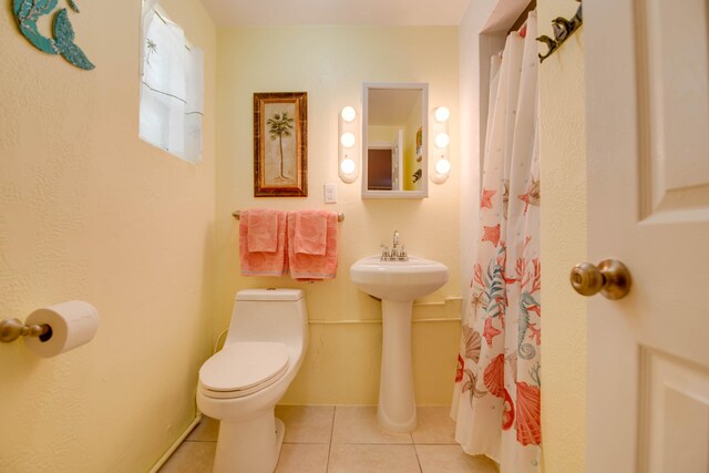 bathroom featuring tile patterned flooring and toilet