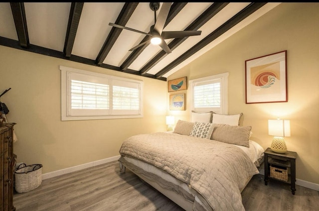 bedroom with dark wood-type flooring, vaulted ceiling with beams, and ceiling fan