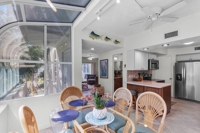 dining room with light tile patterned floors and ceiling fan