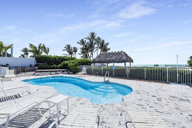 view of swimming pool featuring a fenced in pool, a fenced backyard, and a patio area