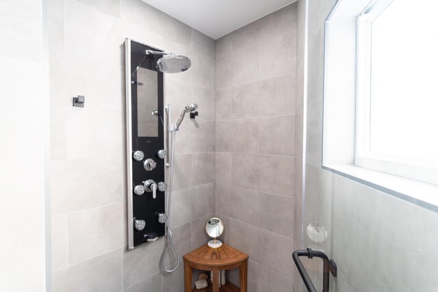 bathroom with a wealth of natural light and a tile shower