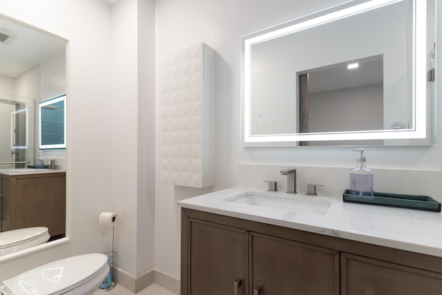 bathroom with vanity and toilet