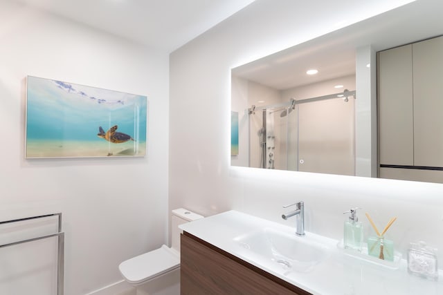 bathroom with vanity, toilet, and an enclosed shower