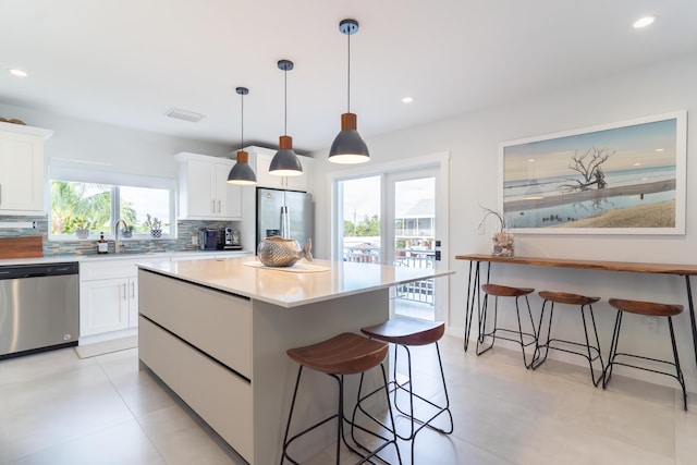 kitchen featuring appliances with stainless steel finishes, sink, and white cabinets