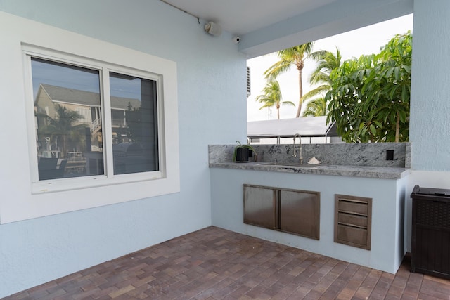 view of patio / terrace featuring sink and an outdoor kitchen