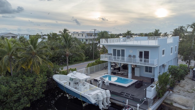 back of house featuring a balcony and a patio area