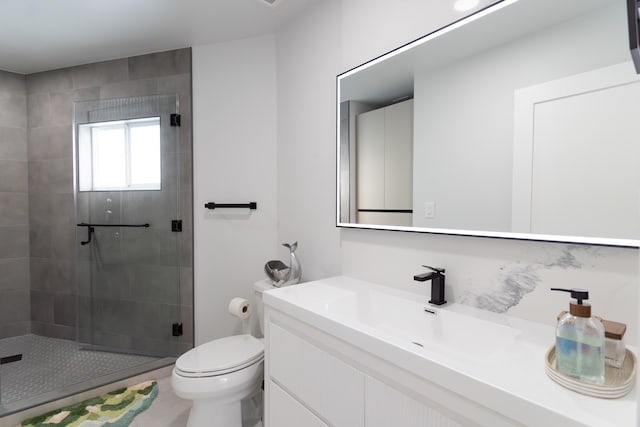 bathroom with vanity, toilet, and an enclosed shower