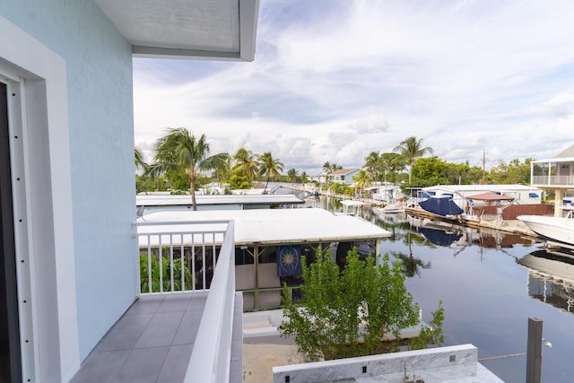 balcony with a water view and a dock