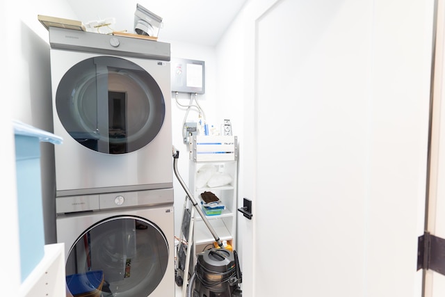 laundry room featuring stacked washer / drying machine