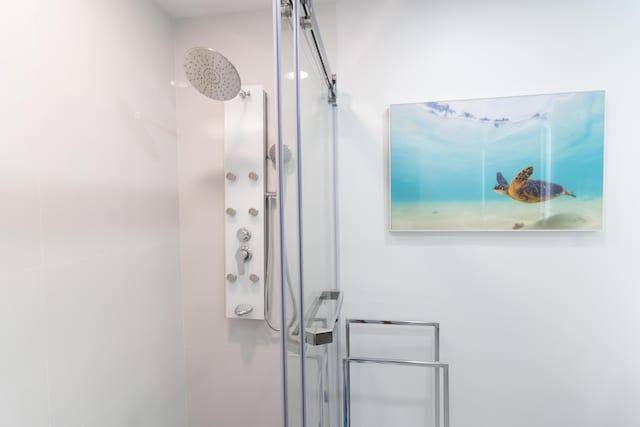 interior space featuring a shower with door