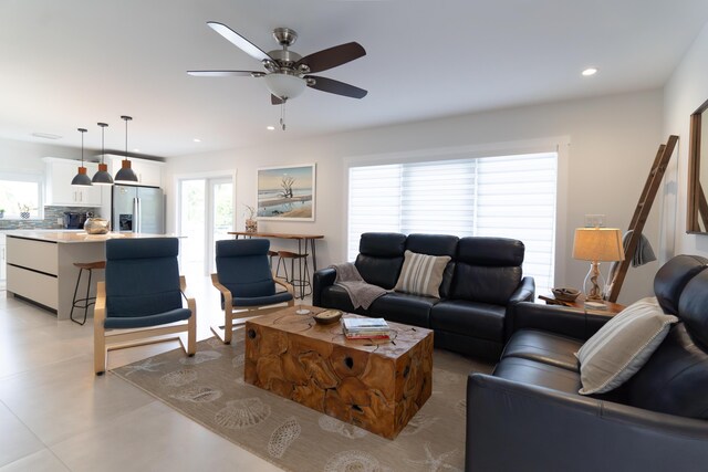 living room featuring a wealth of natural light and ceiling fan