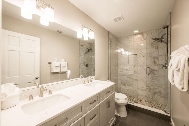 bathroom with vanity, tile patterned flooring, a shower with shower door, and toilet