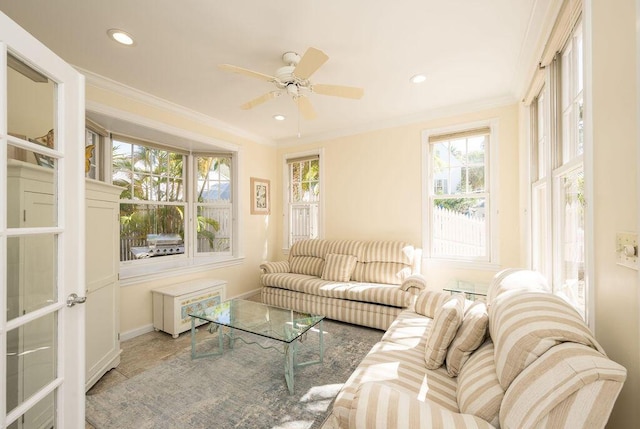 living room with crown molding and ceiling fan