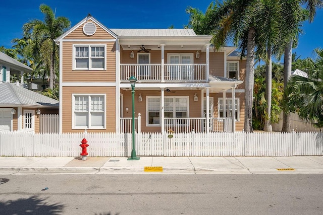 view of front of home featuring a balcony, ceiling fan, and covered porch