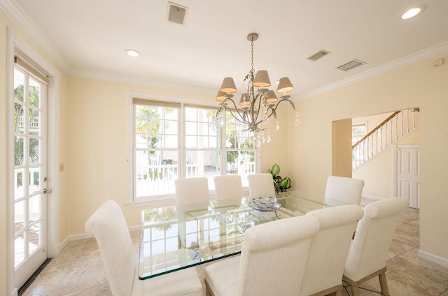 dining area featuring crown molding and a chandelier