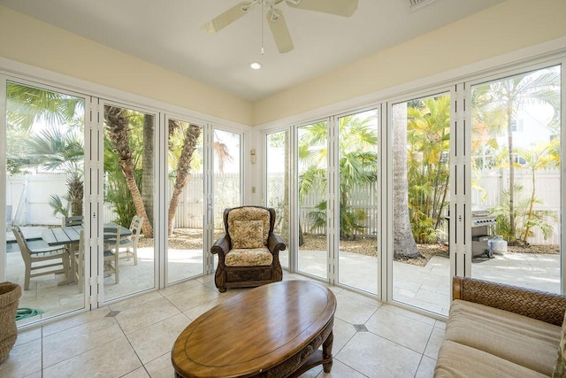 sunroom featuring ceiling fan