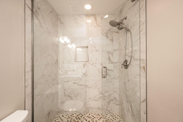 bathroom with toilet and walk in shower