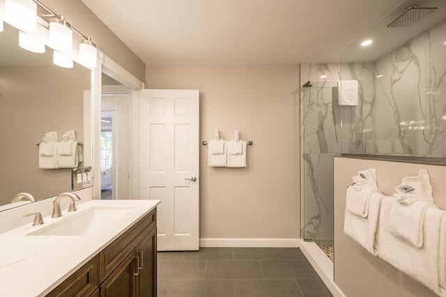 bathroom featuring vanity, tile patterned flooring, and tiled shower