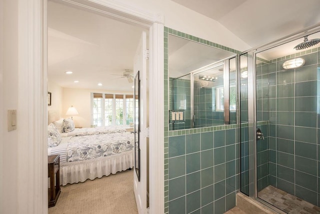 bathroom with lofted ceiling, a shower with door, and ceiling fan