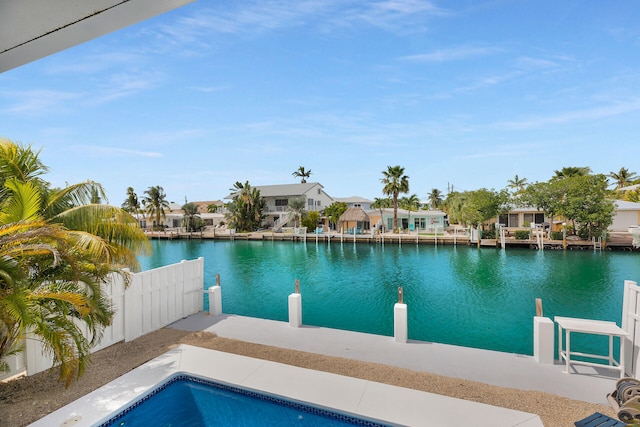 view of pool featuring a patio and a water view