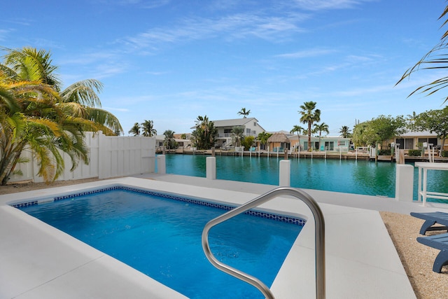 view of swimming pool with a water view