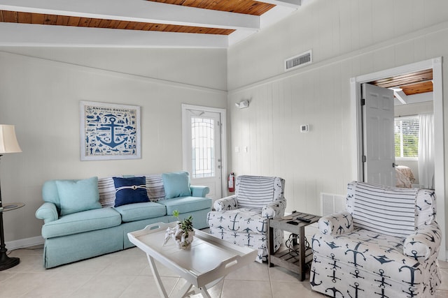 living room featuring vaulted ceiling with beams, wooden ceiling, and light tile patterned floors