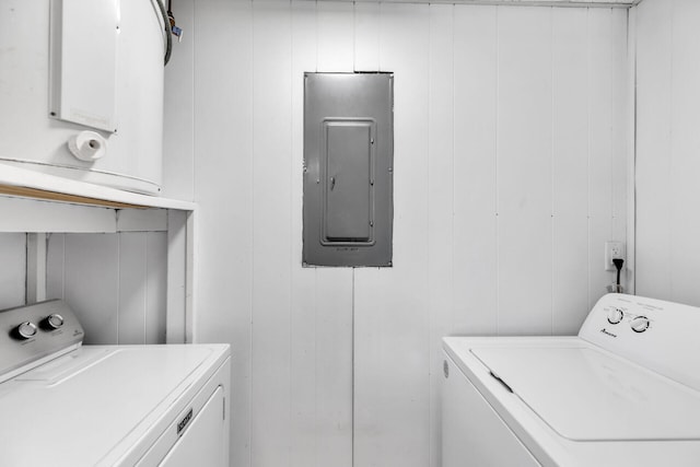 laundry area with washing machine and clothes dryer and electric panel