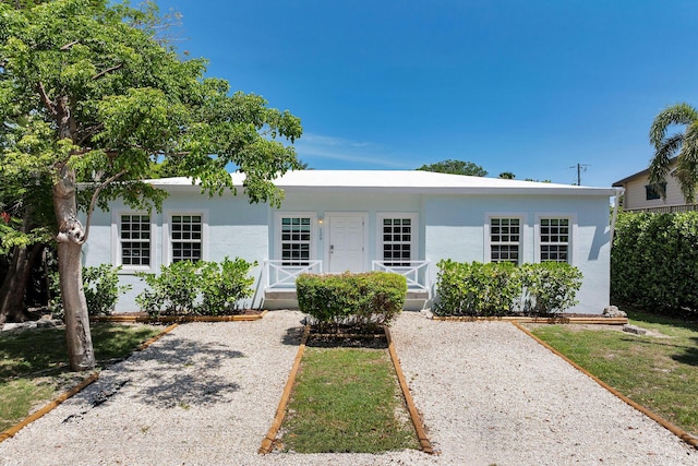 129 Tavern Dr, Tavernier, FL 33070 - ranch-style home featuring a porch and stucco siding
