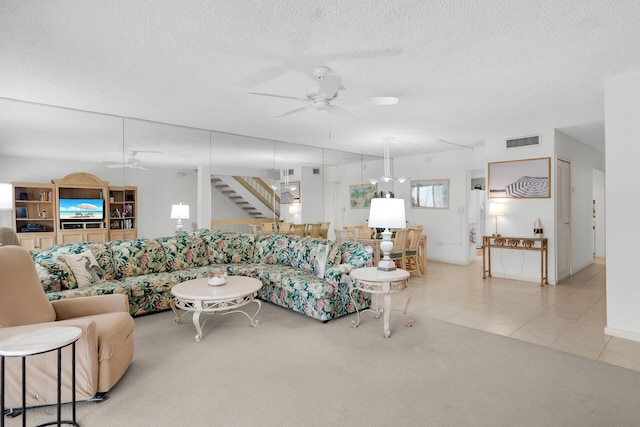 601 W Ocean Dr Unit 411C, Key Colony, FL 33051 - tiled living area with ceiling fan, carpet flooring, a textured ceiling, and stairs