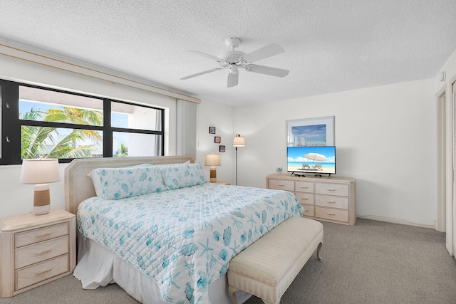 601 W Ocean Dr Unit 411C, Key Colony, FL 33051 - bedroom featuring light carpet, a textured ceiling, and ceiling fan
