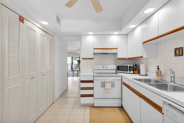 601 W Ocean Dr Unit 411C, Key Colony, FL 33051 - kitchen with white appliances, a ceiling fan, a sink, under cabinet range hood, and backsplash