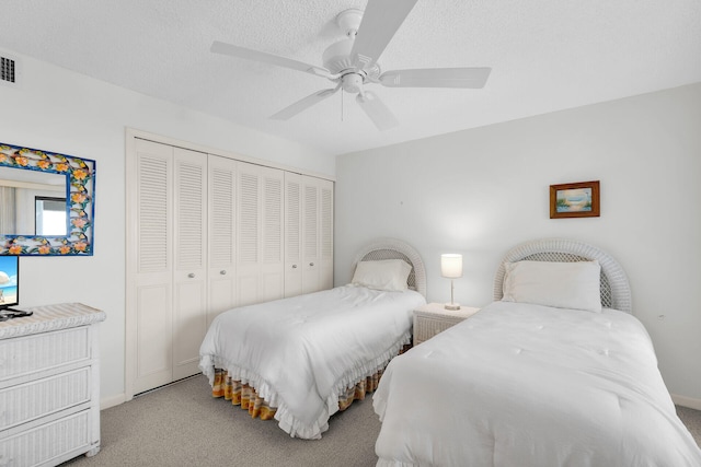 601 W Ocean Dr Unit 411C, Key Colony, FL 33051 - bedroom with carpet flooring, a closet, a ceiling fan, baseboards, and a textured ceiling