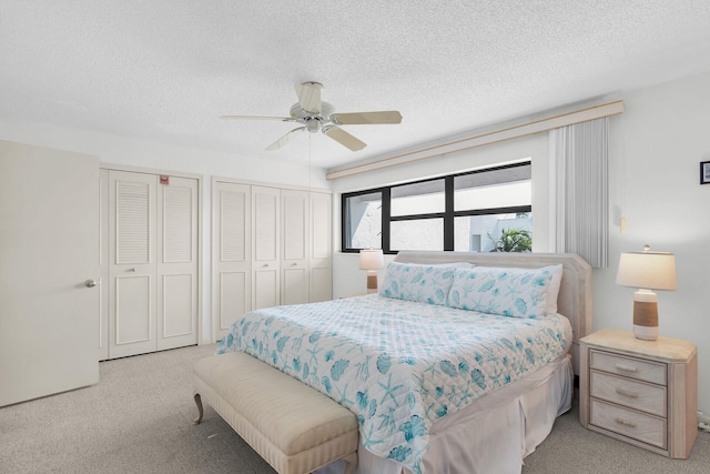 601 W Ocean Dr Unit 411C, Key Colony, FL 33051 - bedroom with multiple closets, light carpet, a textured ceiling, and ceiling fan