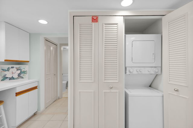 601 W Ocean Dr Unit 411C, Key Colony, FL 33051 - laundry area with stacked washing machine and dryer, light tile patterned floors, and recessed lighting