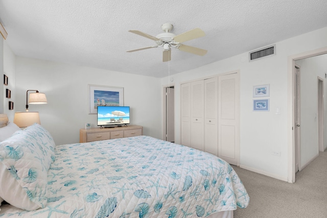 601 W Ocean Dr Unit 411C, Key Colony, FL 33051 - bedroom with carpet flooring, a closet, ceiling fan, a textured ceiling, and baseboards