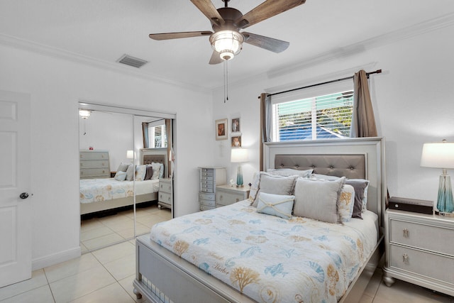 tiled bedroom featuring ornamental molding, a closet, and ceiling fan