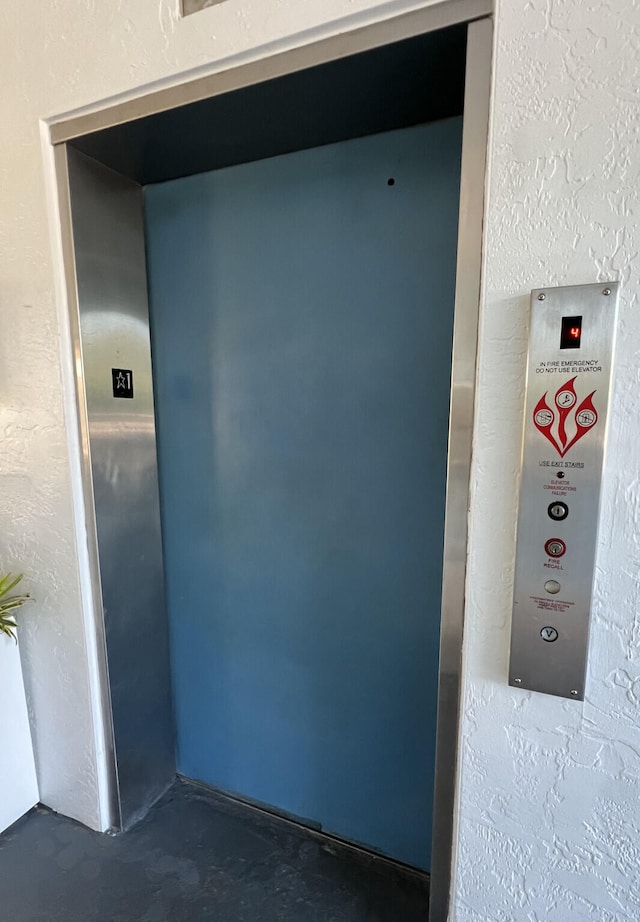 interior details featuring concrete flooring and elevator