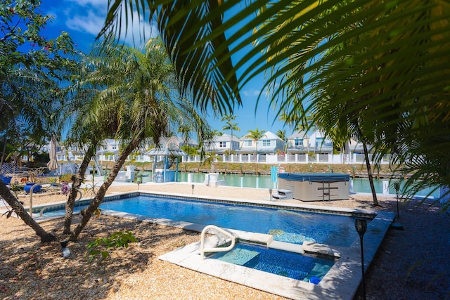 outdoor pool featuring a residential view and an outdoor hot tub