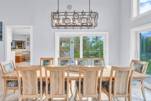 dining room with a chandelier and a high ceiling