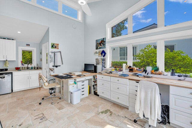 home office featuring a high ceiling and sink