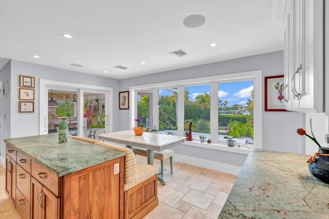 kitchen with light stone counters and a kitchen island