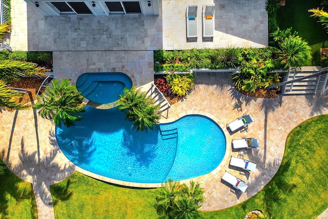 view of swimming pool featuring a jacuzzi