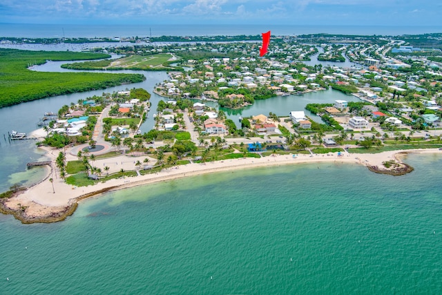 bird's eye view featuring a water view and a beach view