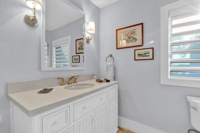 bathroom featuring vanity and toilet