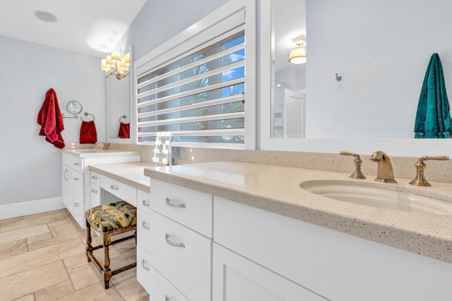 bathroom with vanity and a notable chandelier